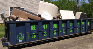 a dumpster full of furniture outside of a house