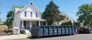 a dumpster outside a suburban house
